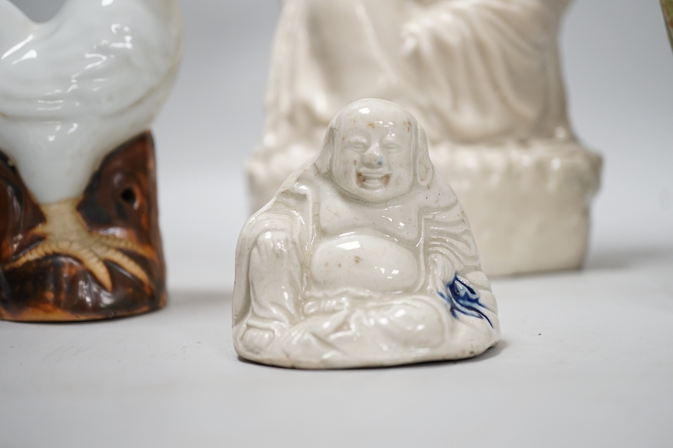 A Chinese enamelled blanc de chine figure of Guanyin, together with three other figures. 28cm tall